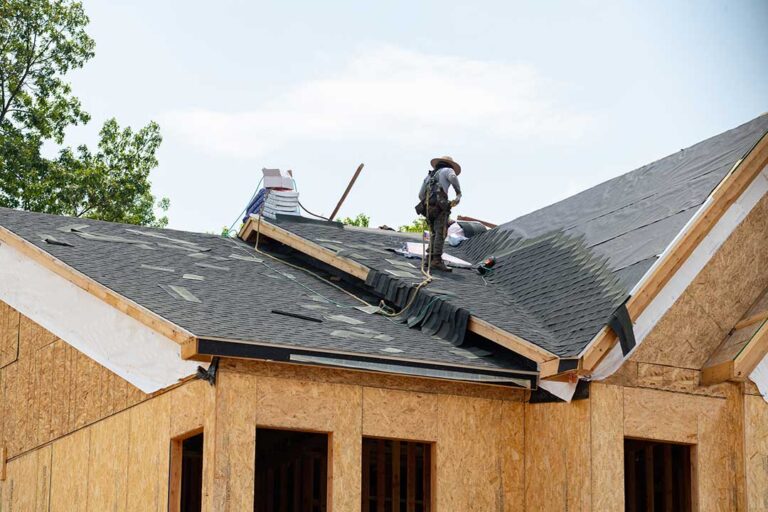 Dry holiday decoration boxes stored neatly on an attic platform away from roof vents and insulation.